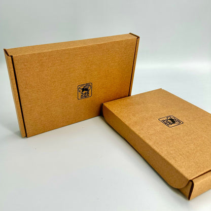 Brown cardboard boxes with a company logo for 2d6 Designs (2d6.co.uk), that show how the line art sculptures will arrive