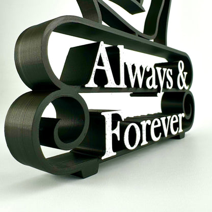 Matte black plastic decorative sculpture with marble 'Always & Forever' text on a white background
