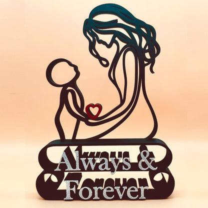 A line art sculpture of a mother and child with a red heart, the words 'Always & Forever' on the base, and a freestanding base.