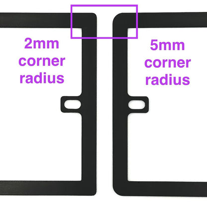 Close-up of two black socket spacers / extension frames with different corner radiuses, showing there are options for how rounded the corners of the plates are (2mm radius or 5mm radius).